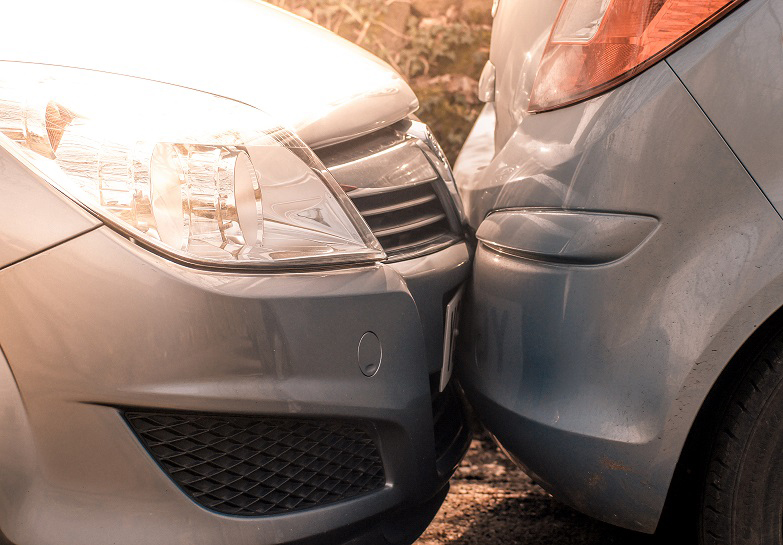 A car lightly hitting the back of another car in-front