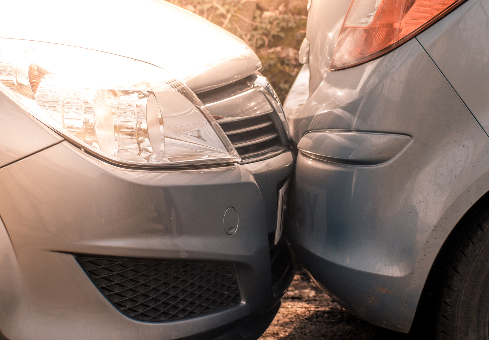 A car that has collided into the car in-front causing minor damage