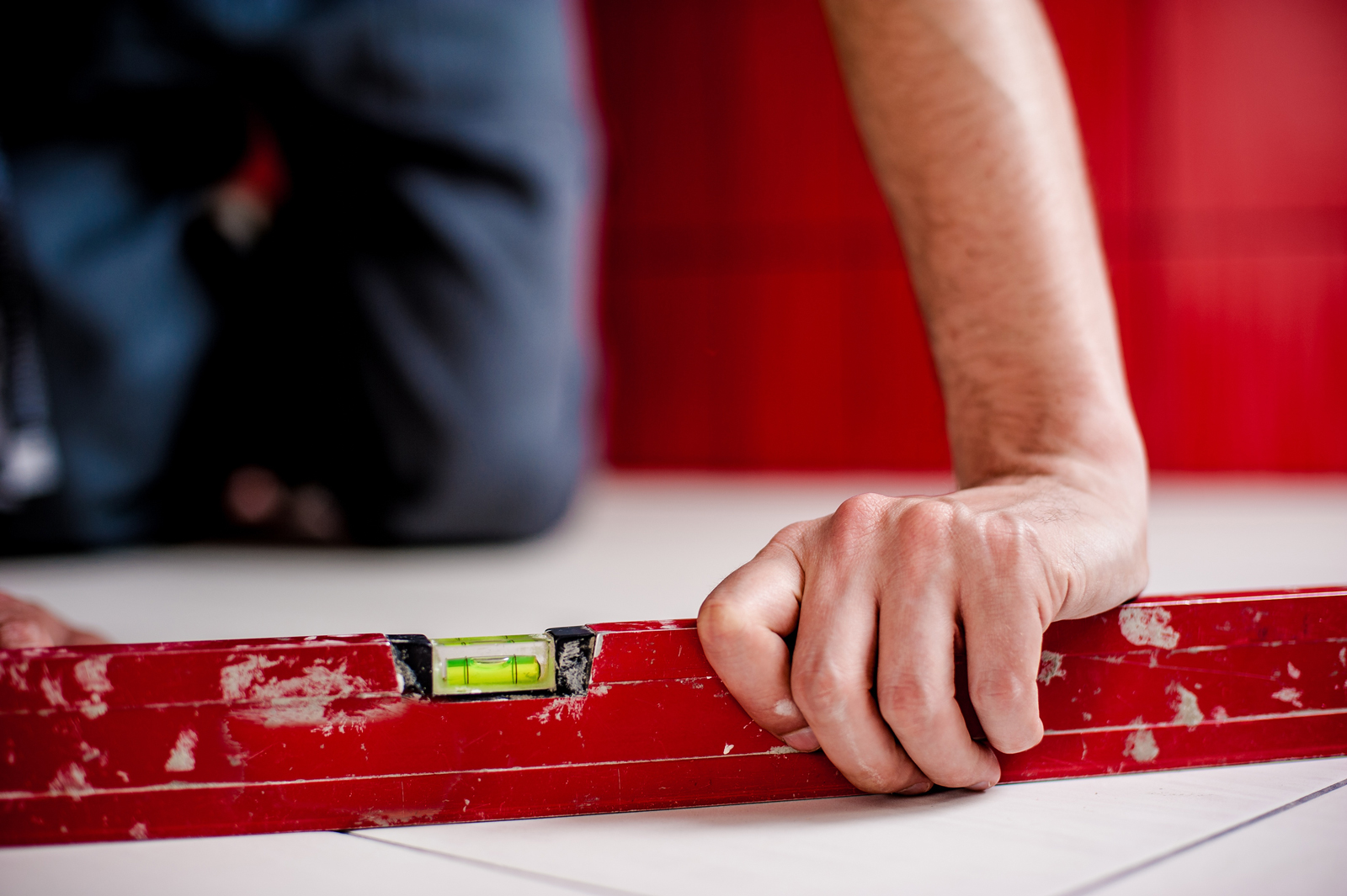 A construction worker using a spirit level on site