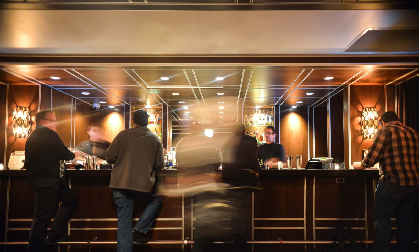 A bar with customers ordering drinks