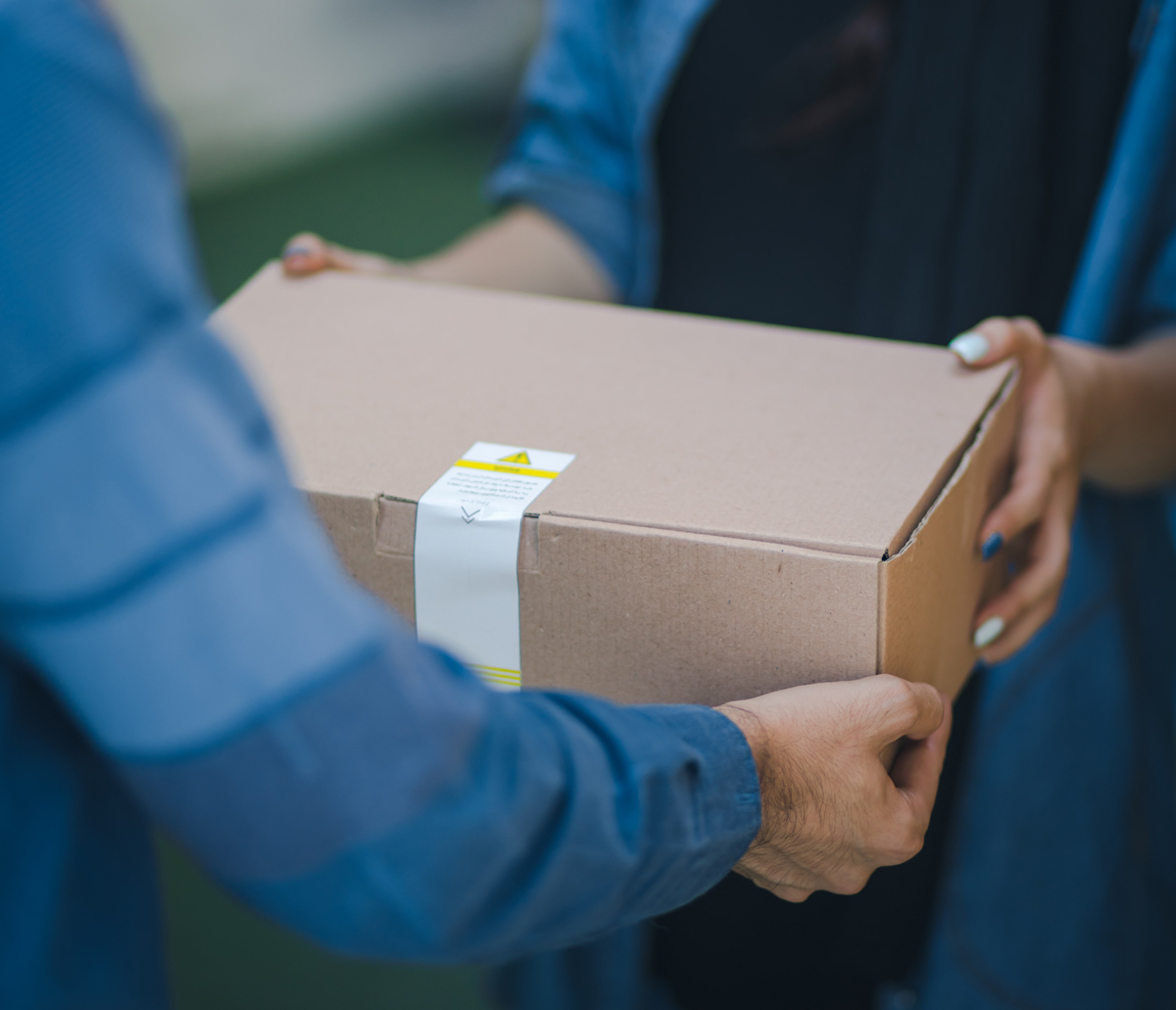 A delivery driver handing over a package to a customer