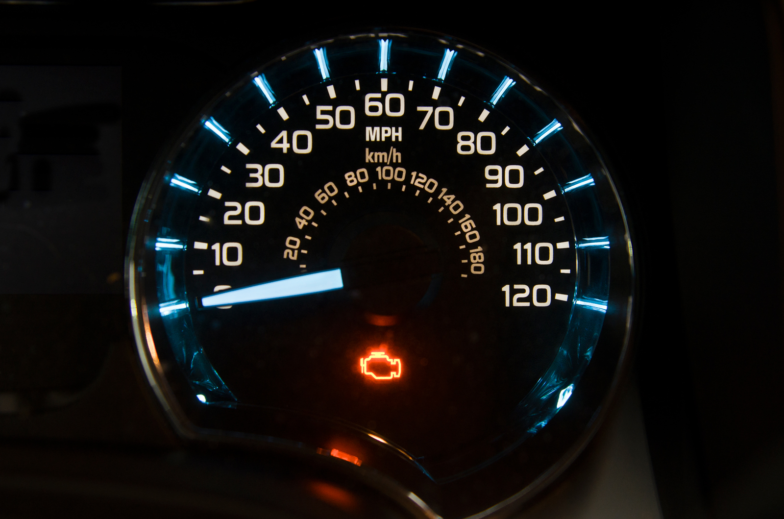 A van speedo with an engine warning light lit up