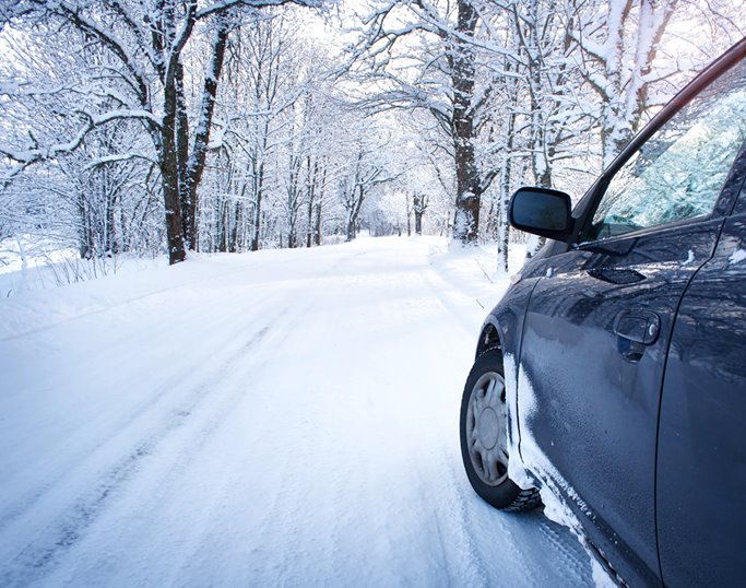 A car driving down a snowy road
