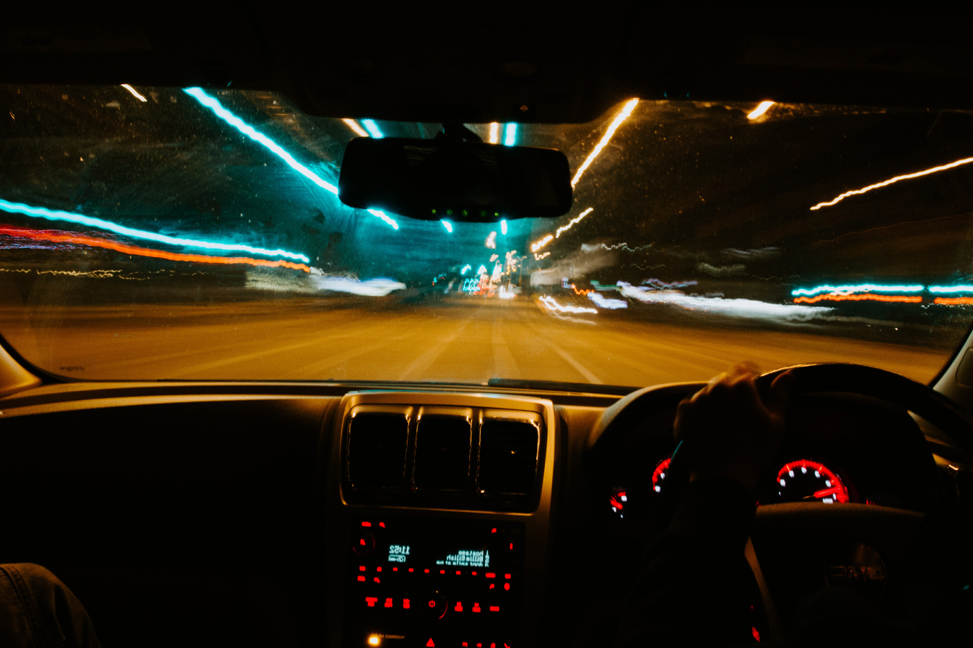 A drivers perspective of driving under the influence with blurred lights at the road side