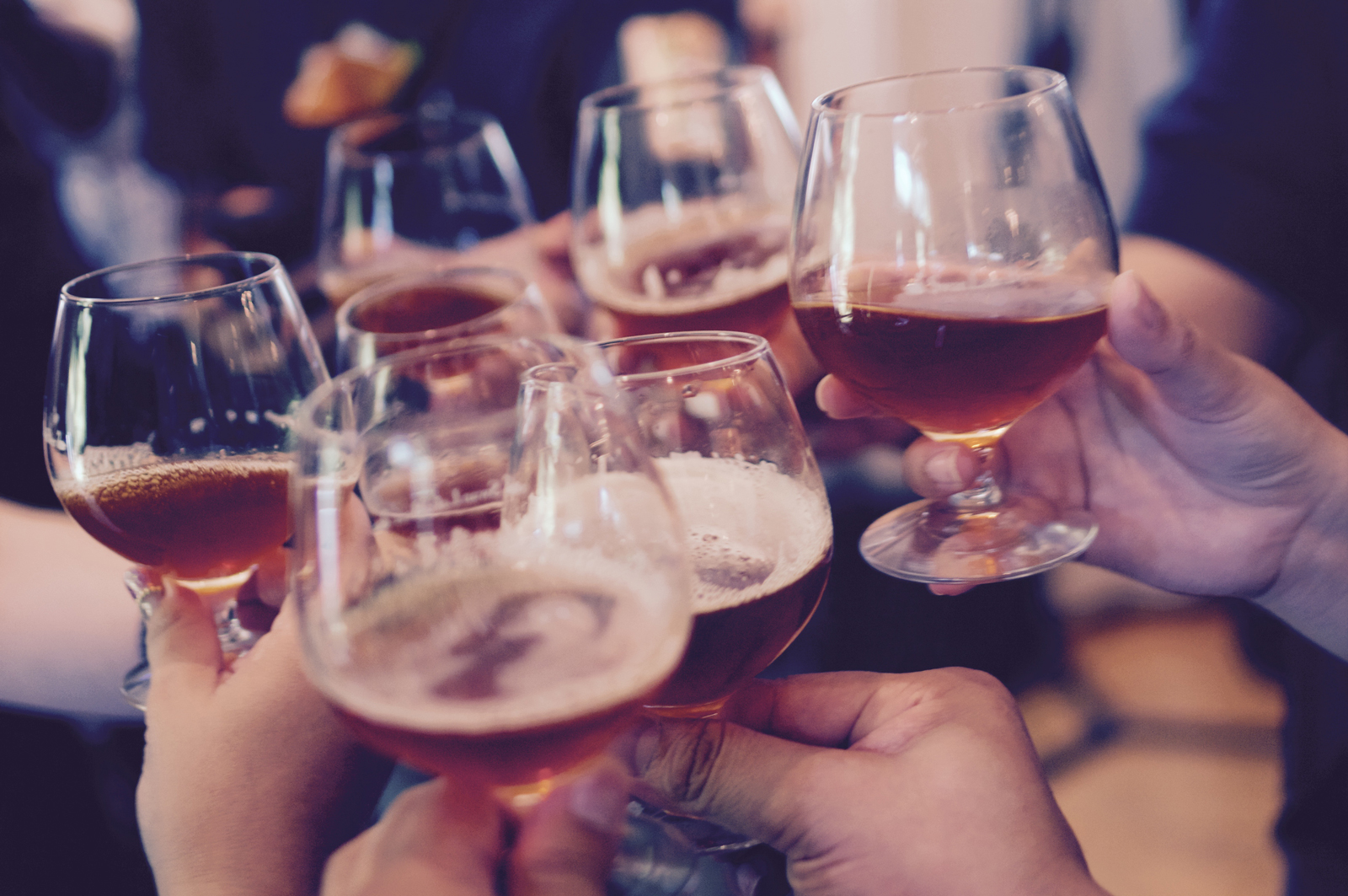 A group of people clinking glasses of beer together