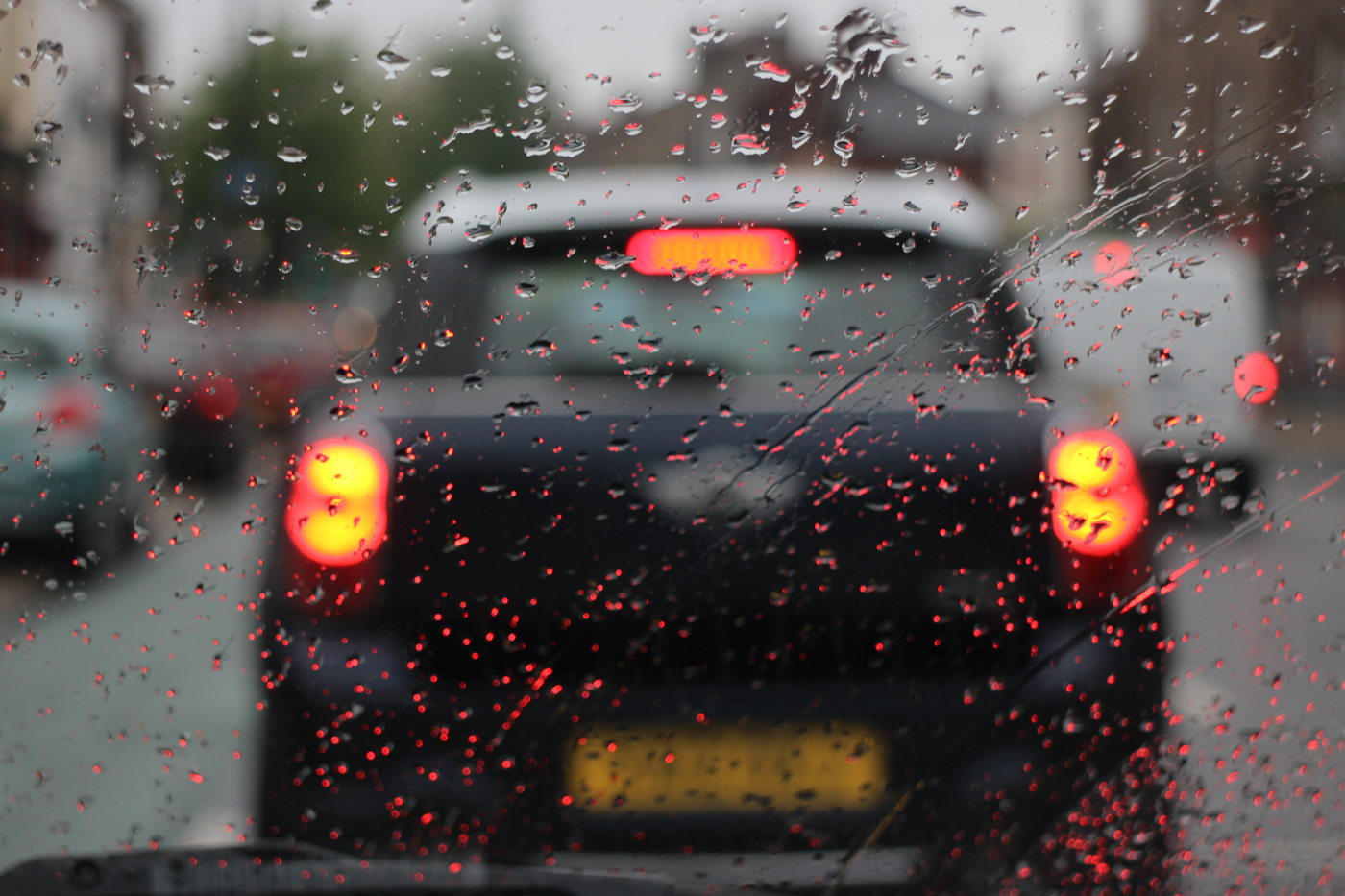 A rain covered windscreen on a wet day in traffic