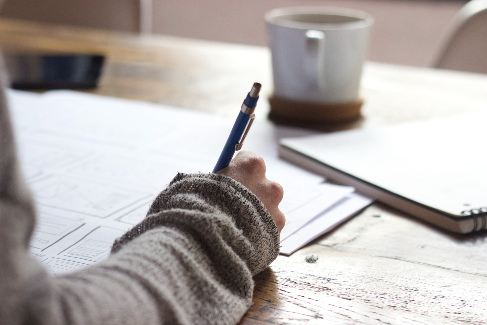 A person studying writing in a note book