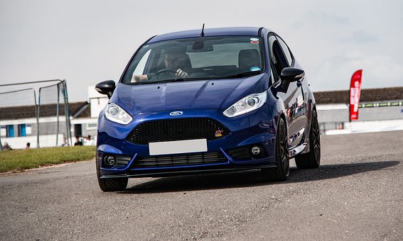A blue Ford Fiesta on a track