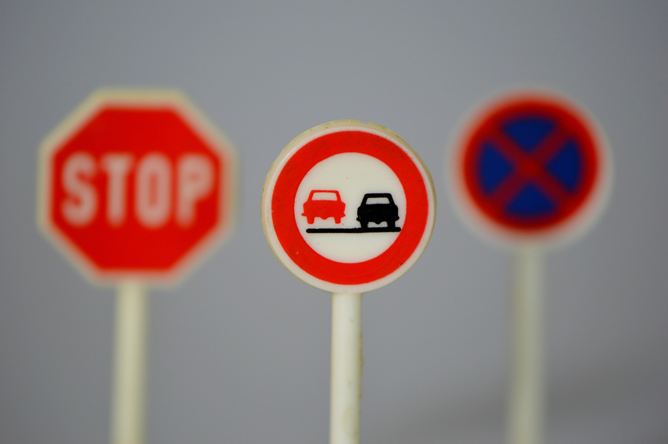 Three road signs against a plain backgrond