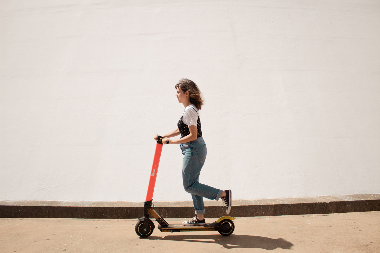 A woman riding an e-scooter