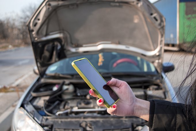 Broke-Down-on-Phone.jpg Person calling for recovery in-front of broken down car