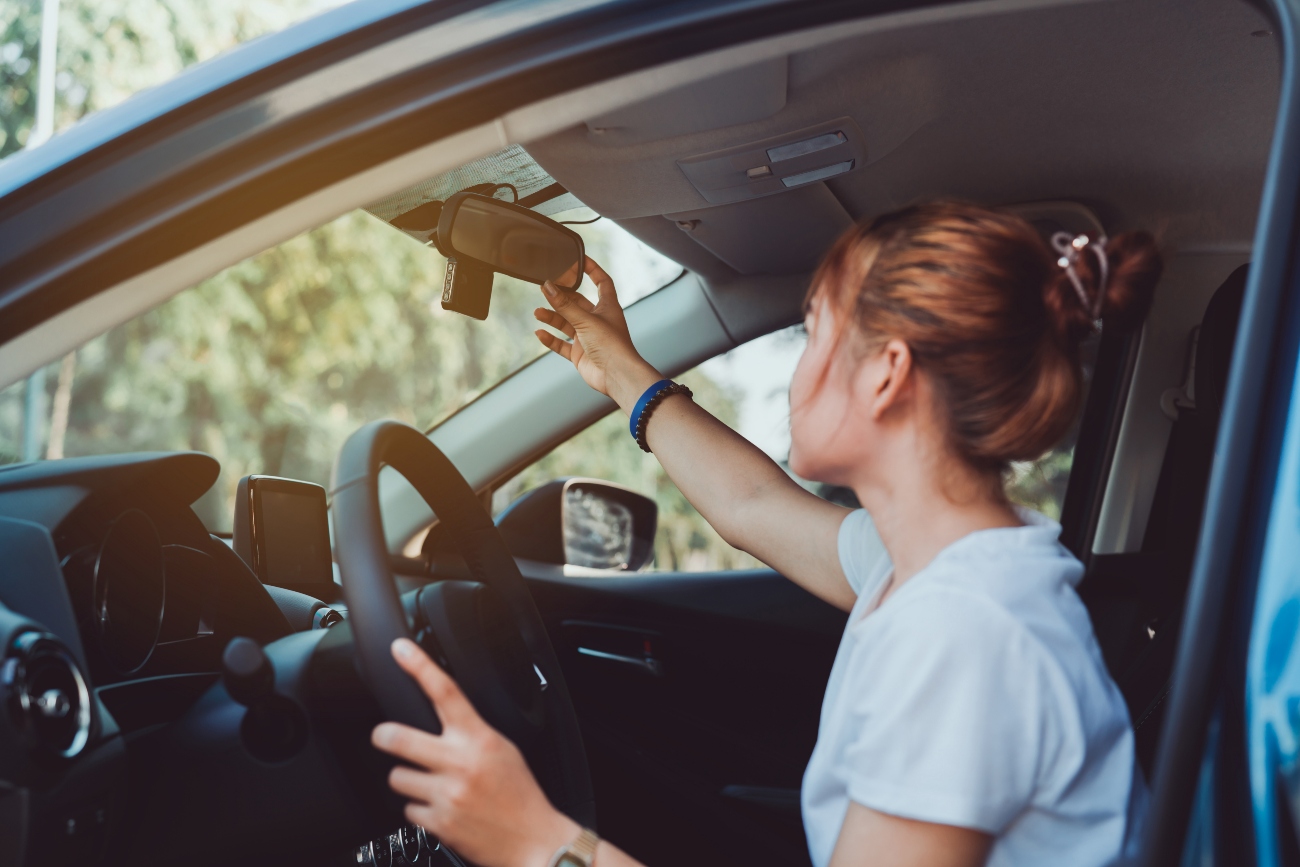 Young-woman-checking-her-car-mirrors.jpg