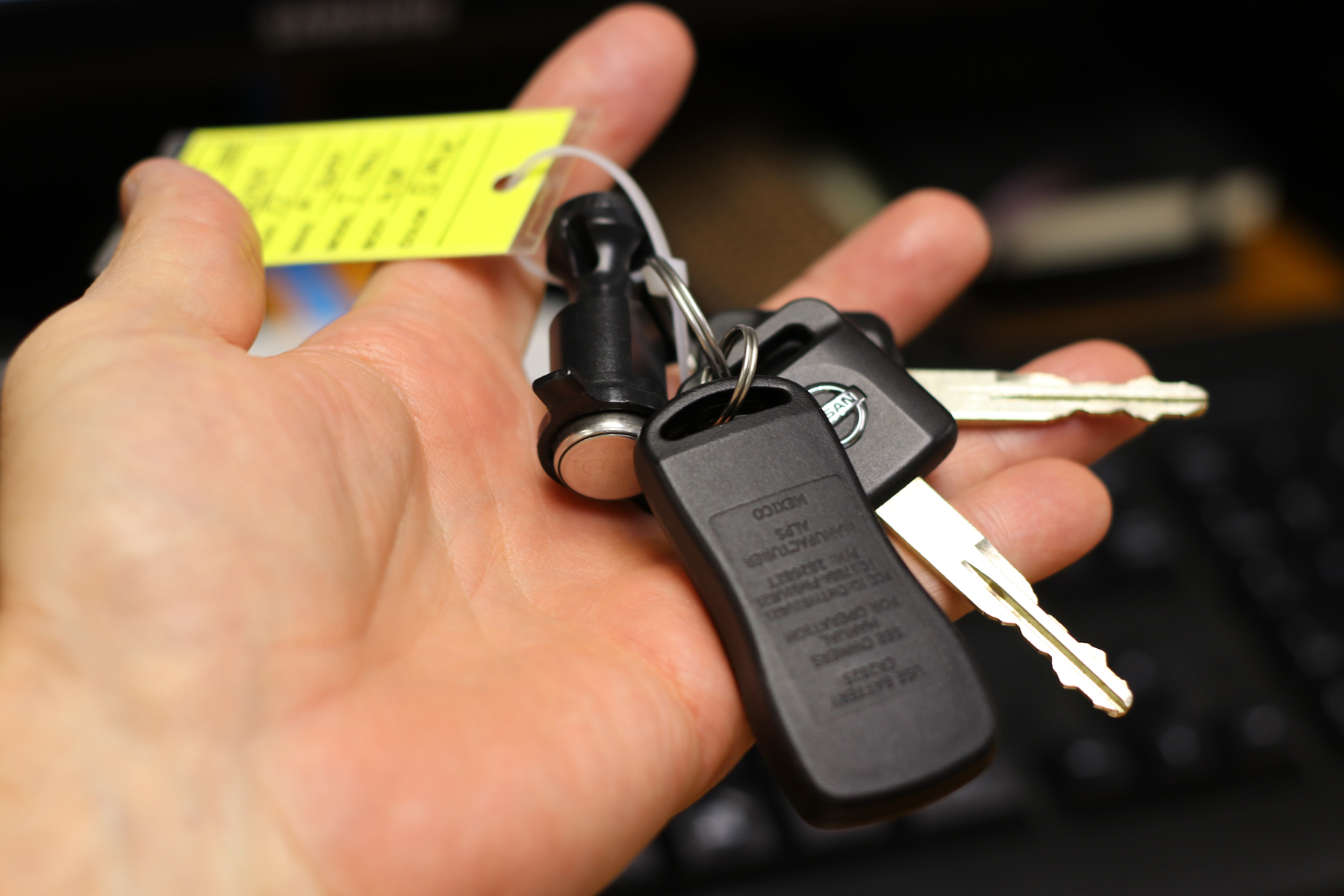 A persons hand holding the keys to a van they have just bought